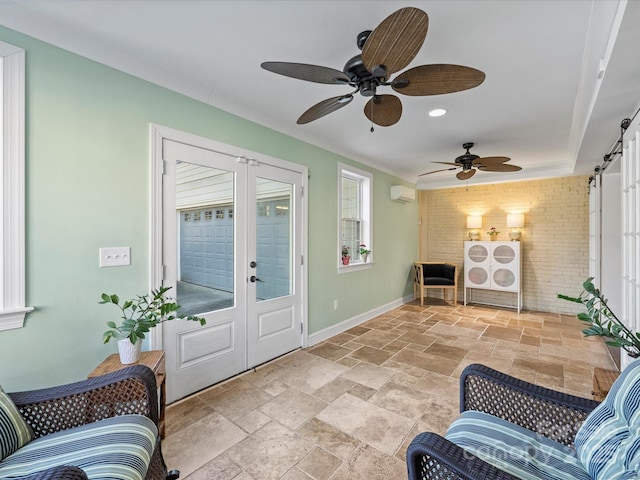 foyer entrance with a barn door, french doors, brick wall, and a wall mounted AC