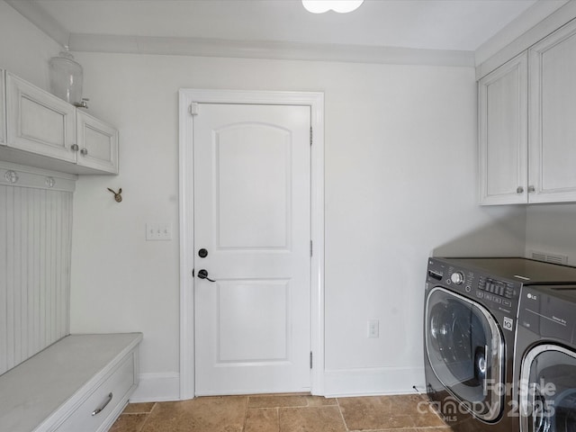 laundry room featuring cabinets, ornamental molding, and washing machine and clothes dryer