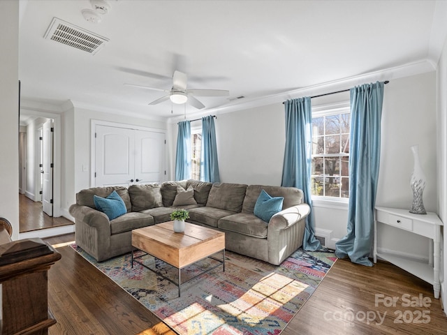 living room featuring ceiling fan, wood-type flooring, and ornamental molding