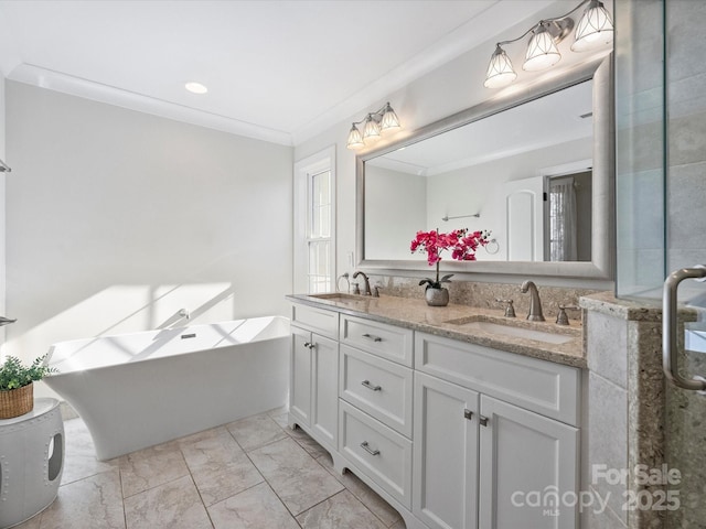 bathroom with ornamental molding, a bathing tub, and vanity