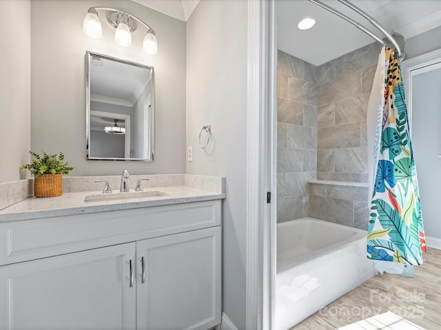 bathroom featuring crown molding, wood-type flooring, shower / bath combination with curtain, and vanity