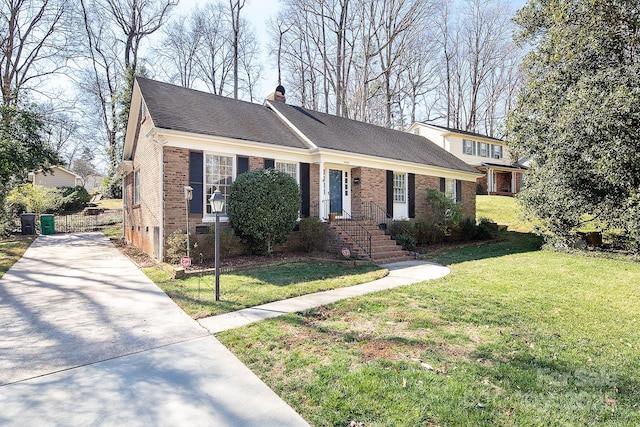 view of front of home with brick siding, a shingled roof, concrete driveway, a front yard, and a chimney