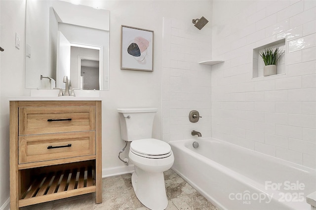 bathroom featuring toilet, shower / bathing tub combination, vanity, and baseboards