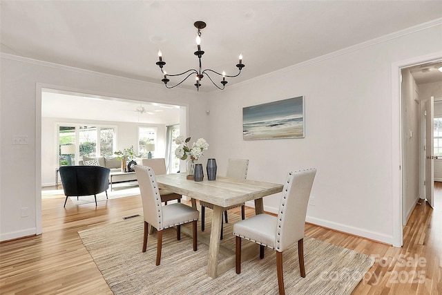 3828 Chandworth Rd, Charlotte, NC 28210 - dining space with light wood finished floors, a chandelier, baseboards, crown molding, and ceiling fan
