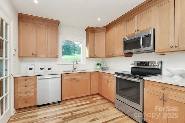 3828 Chandworth Rd, Charlotte, NC 28210 - kitchen with stainless steel appliances, a sink, light wood finished floors, light stone counters, and recessed lighting