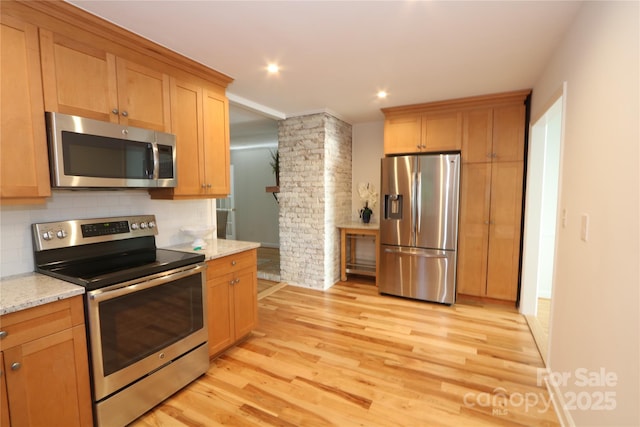 3828 Chandworth Rd, Charlotte, NC 28210 - kitchen with appliances with stainless steel finishes, light wood finished floors, backsplash, light stone countertops, and recessed lighting