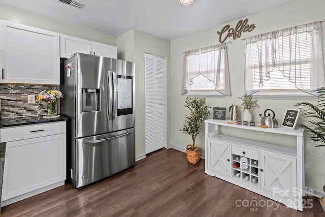 kitchen featuring stainless steel refrigerator with ice dispenser, dark hardwood / wood-style flooring, tasteful backsplash, and white cabinets