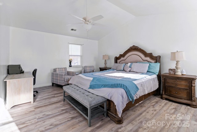 bedroom with vaulted ceiling, light hardwood / wood-style floors, and ceiling fan