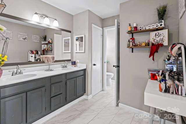 bathroom featuring vanity and toilet