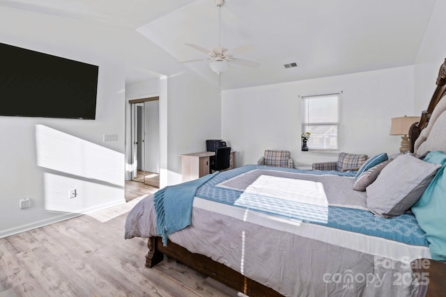 bedroom with vaulted ceiling, ceiling fan, and light hardwood / wood-style floors