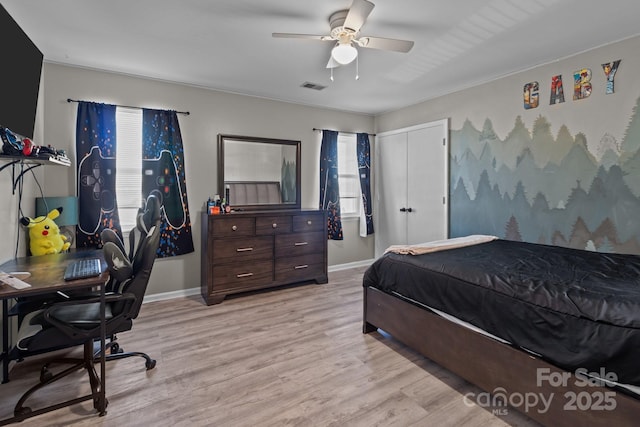 bedroom featuring a closet, ceiling fan, and light hardwood / wood-style floors