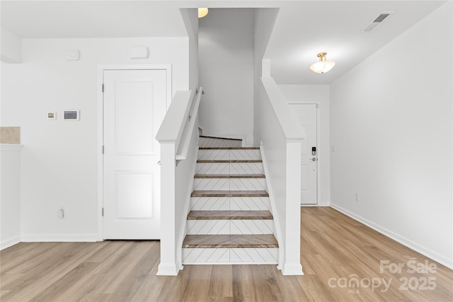 staircase featuring hardwood / wood-style flooring