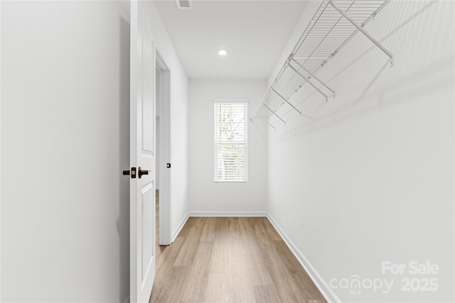 walk in closet featuring light hardwood / wood-style floors