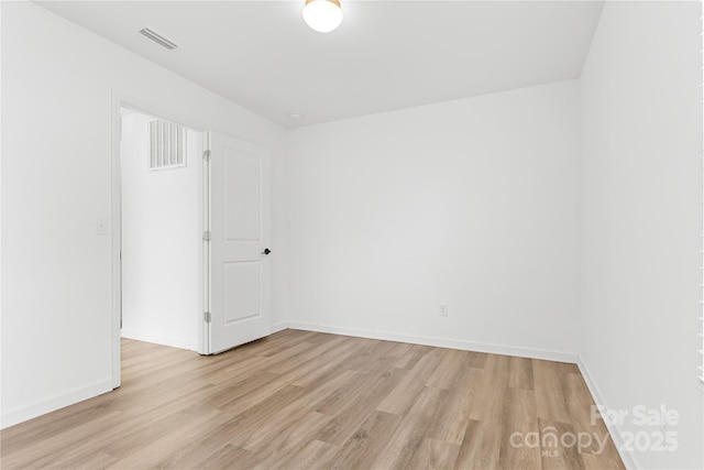 spare room with light hardwood / wood-style flooring