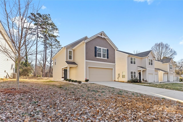 front of property featuring central AC and a garage