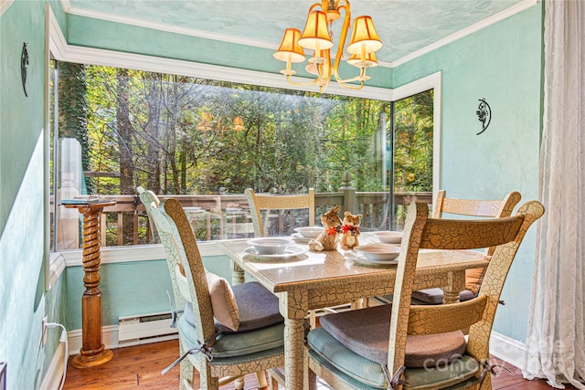 sunroom with baseboard heating and a notable chandelier