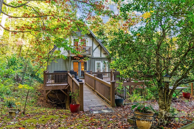 back of property featuring french doors, a deck, and a balcony