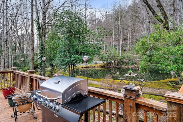 wooden terrace with a grill