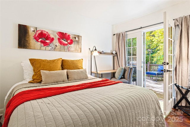 bedroom featuring access to outside and wood finished floors