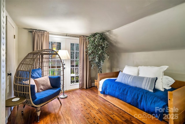 bedroom featuring vaulted ceiling and hardwood / wood-style floors
