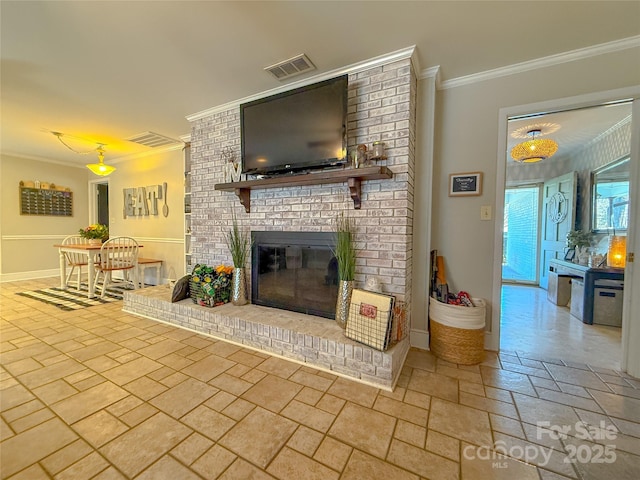 unfurnished living room featuring stone tile flooring, a fireplace, visible vents, and crown molding