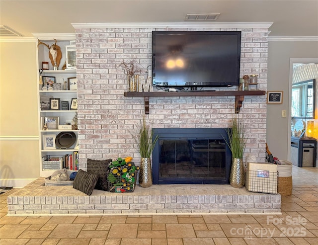 living area with a brick fireplace, visible vents, and crown molding