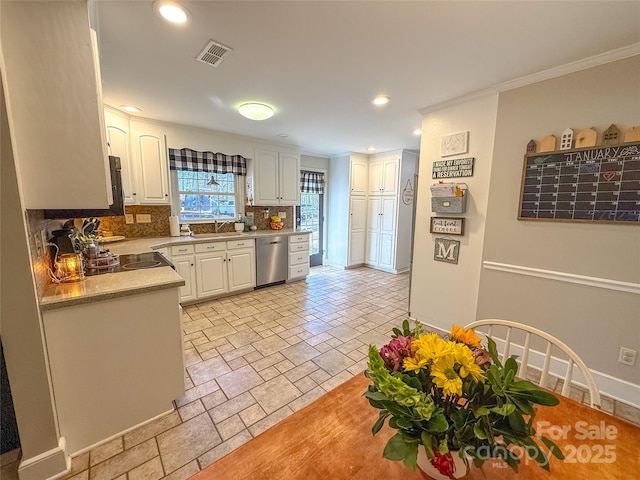 kitchen with white cabinets, visible vents, light countertops, and stainless steel dishwasher