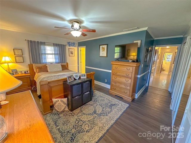 bedroom featuring dark wood finished floors, visible vents, ornamental molding, a ceiling fan, and baseboards