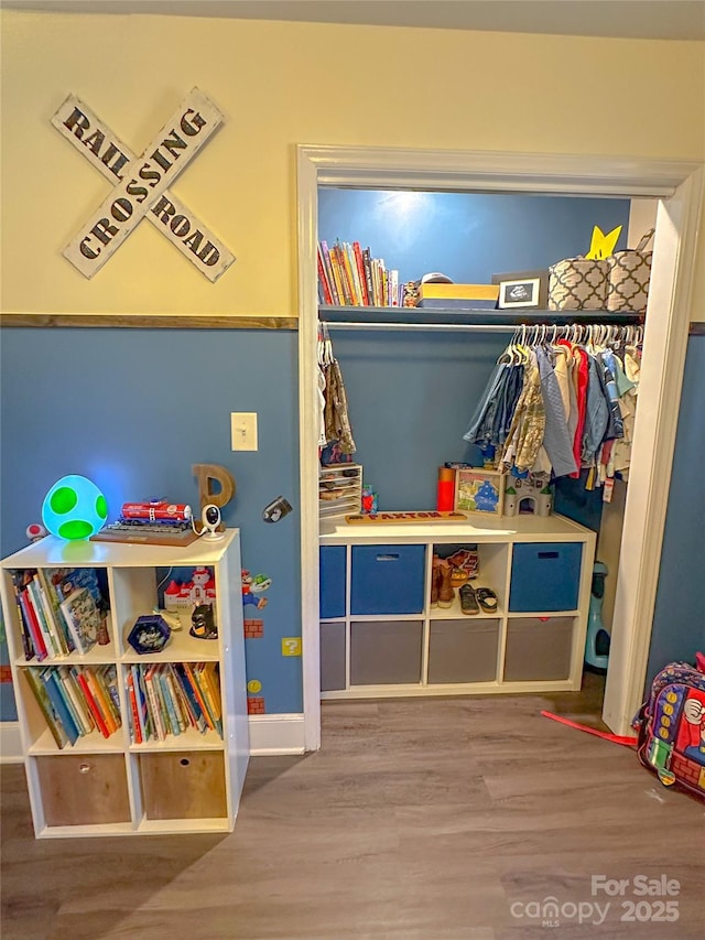 rec room featuring wood finished floors and baseboards