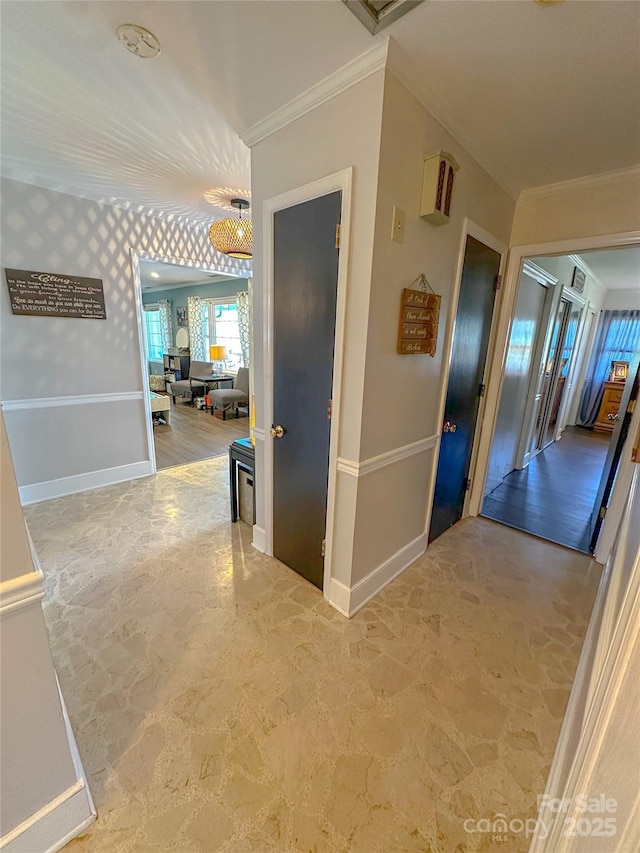 corridor with crown molding and baseboards