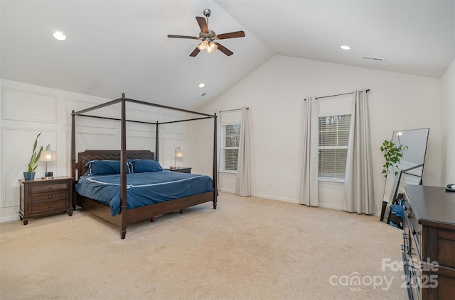 bedroom featuring vaulted ceiling, light colored carpet, and ceiling fan