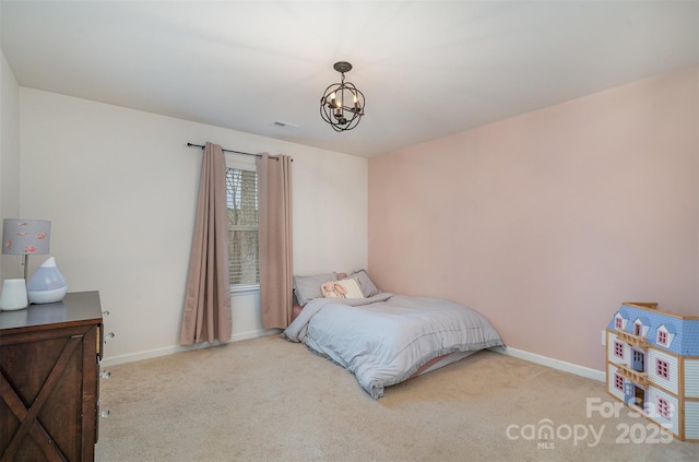 carpeted bedroom featuring a notable chandelier