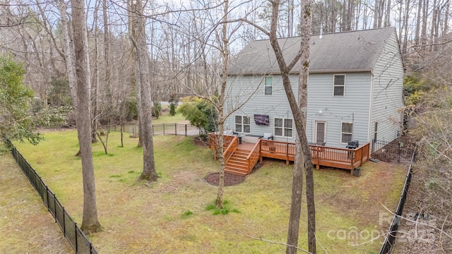 back of property featuring a deck and a lawn