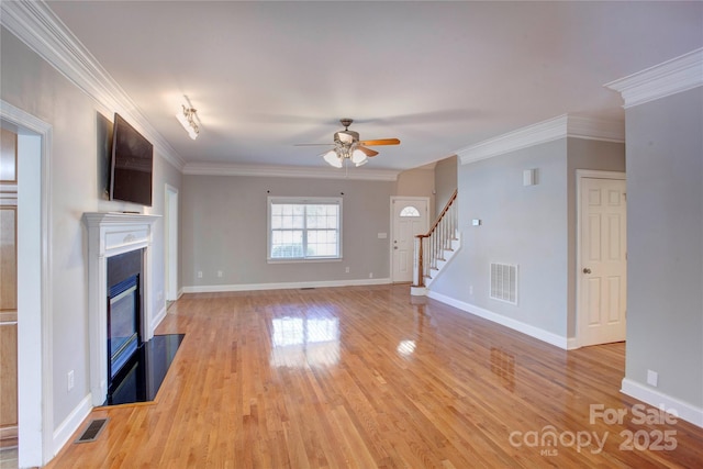 unfurnished living room featuring light wood-type flooring, ceiling fan, and ornamental molding