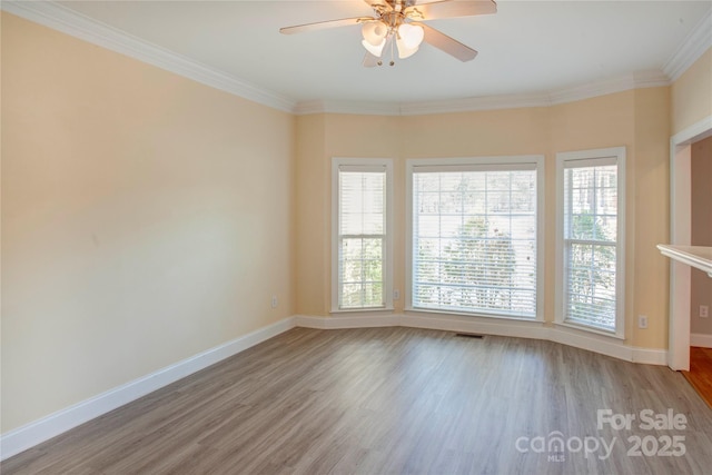 unfurnished room with crown molding, light wood-type flooring, and ceiling fan