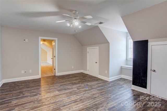 bonus room featuring ceiling fan, dark wood-type flooring, and lofted ceiling