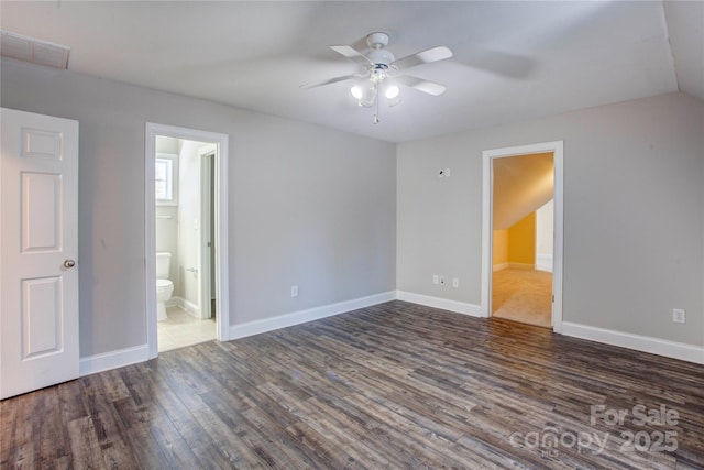 empty room with ceiling fan and dark hardwood / wood-style floors