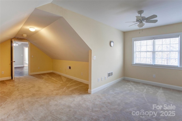 additional living space featuring light carpet, ceiling fan, and lofted ceiling