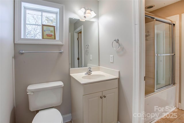 full bathroom featuring vanity, toilet, shower / bath combination with glass door, and tile patterned flooring