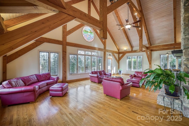 living room with light hardwood / wood-style floors, high vaulted ceiling, beam ceiling, and wood ceiling