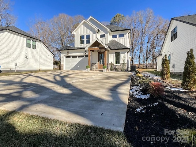 view of front of home with cooling unit and a garage