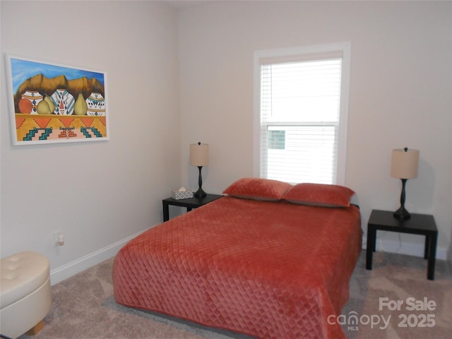 carpeted bedroom featuring baseboards