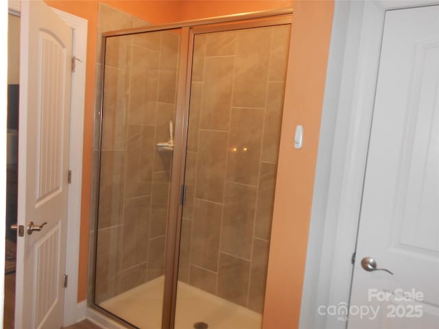 bathroom with a shower stall