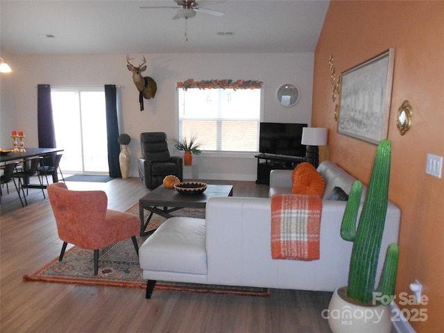 living room featuring plenty of natural light, wood finished floors, and visible vents