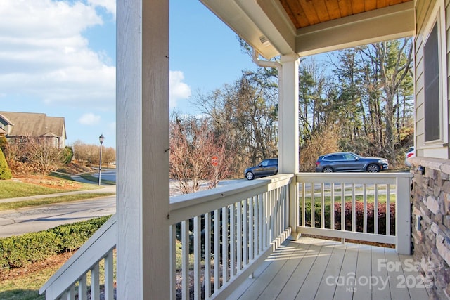 wooden terrace with a porch