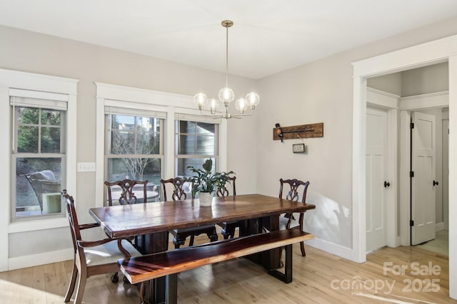 dining area featuring a chandelier and light hardwood / wood-style flooring