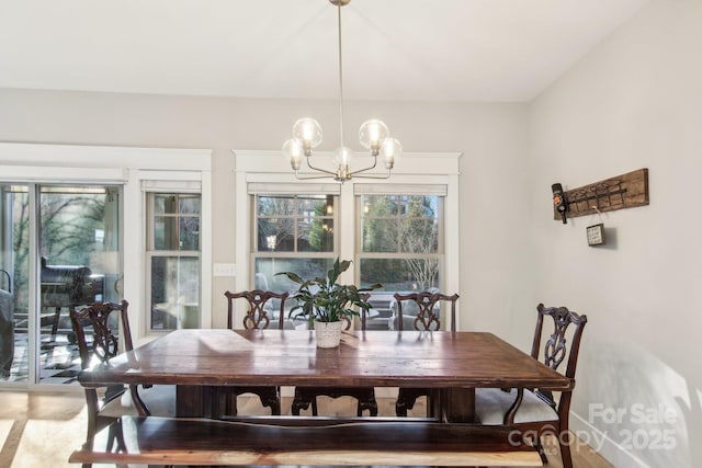 dining area featuring a notable chandelier