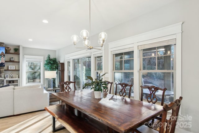 dining room featuring a notable chandelier and light hardwood / wood-style flooring