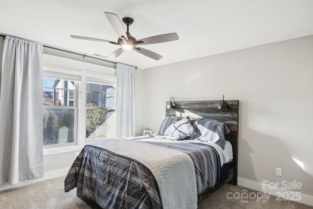 bedroom with ceiling fan and dark carpet