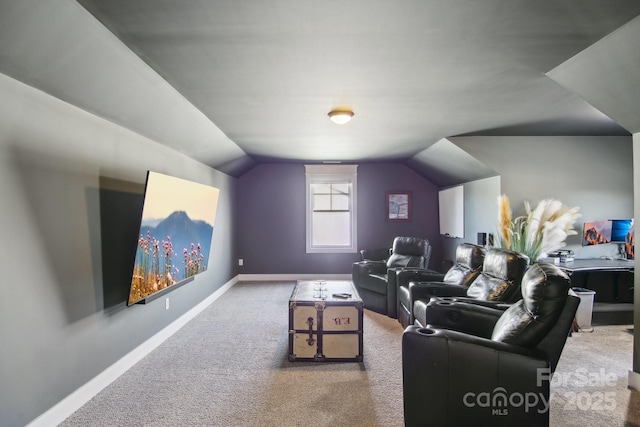 cinema with vaulted ceiling and carpet flooring